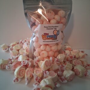 A pile of wrapped peach-flavored candies spilling from a clear bag.