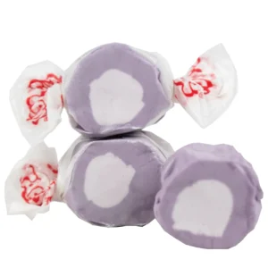 Three purple and white wrapped candies with red designs.