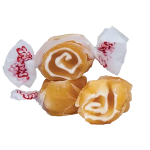 Two caramel swirl candies with two white peppermint candies.