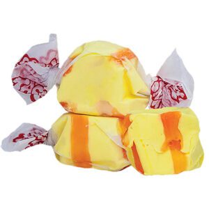 Colorful taffy candies wrapped in white wax paper with red designs.